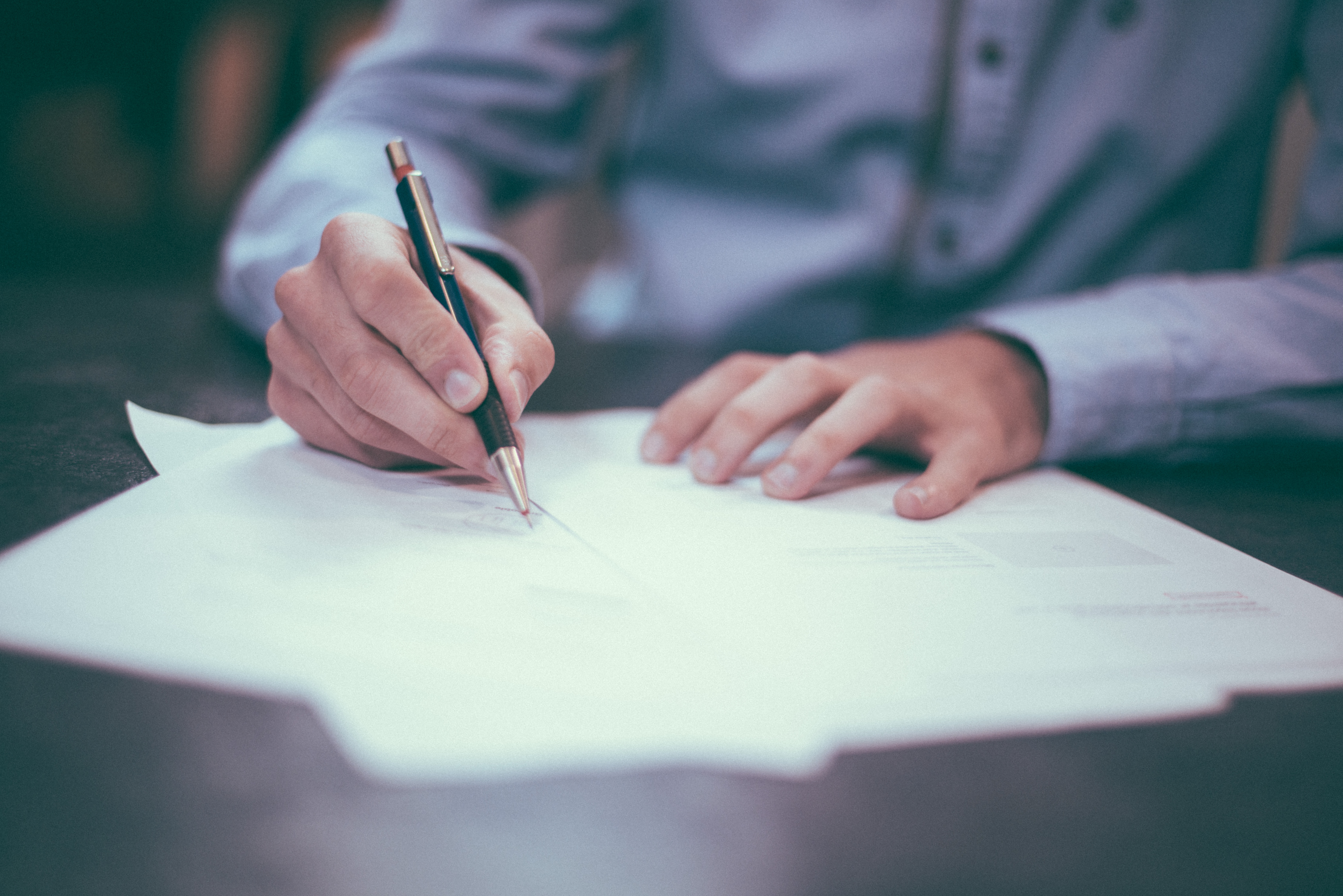 A person writing on paper